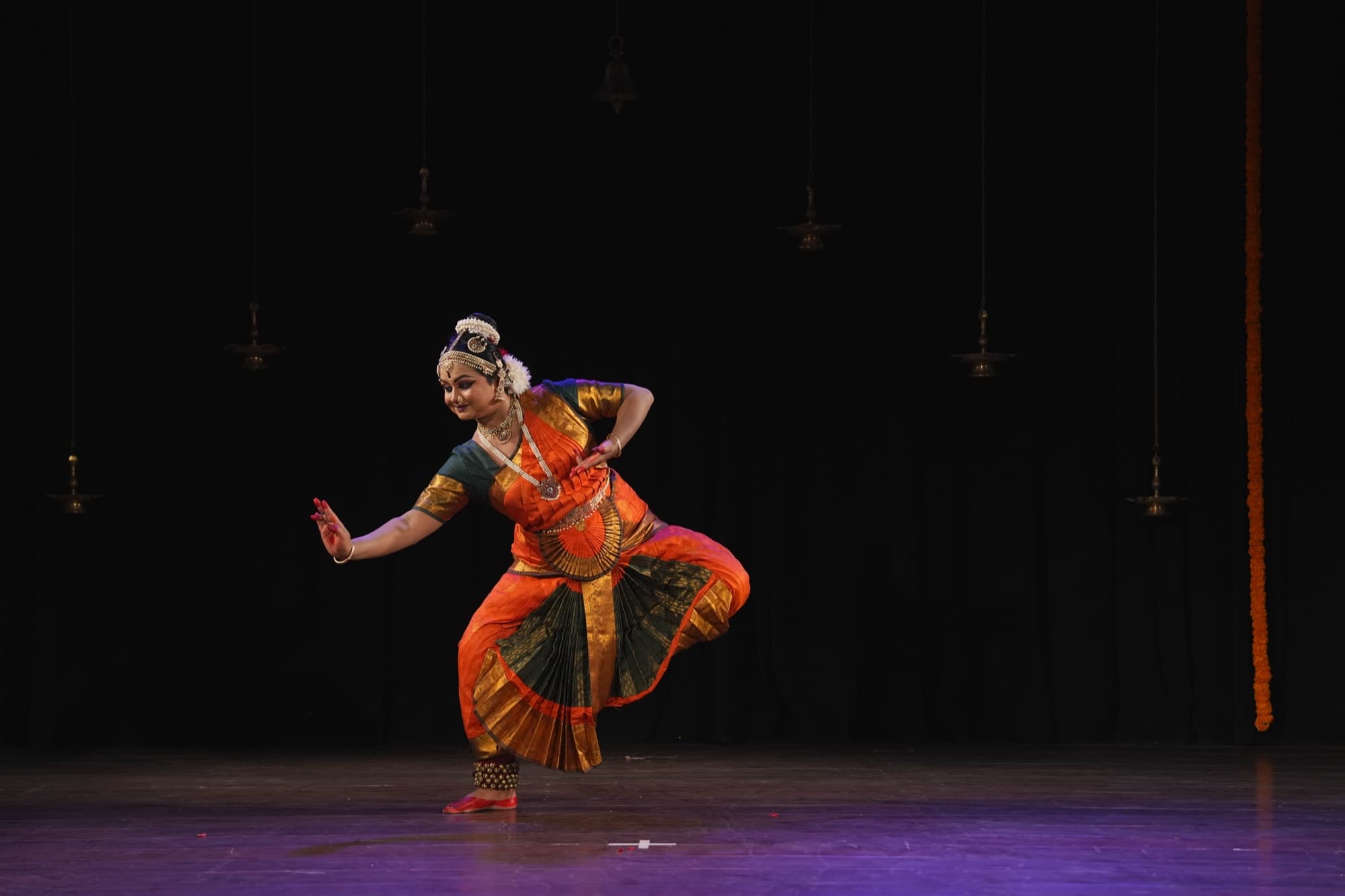A dancer performing on stage at Anura Academy