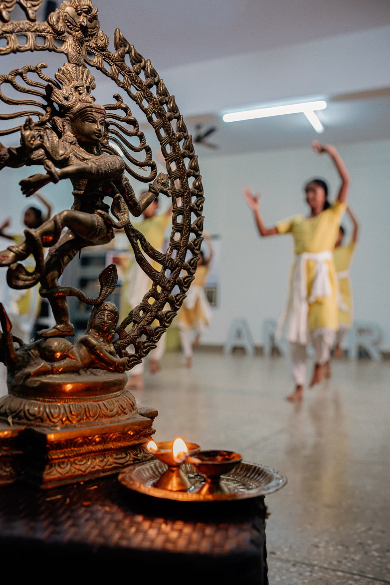 Nataraja idol with students practising in the background
